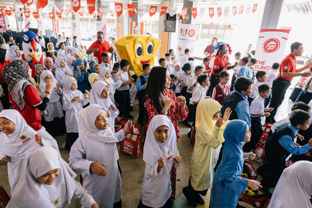 Pizza Hut's Pizza Man in a crowd of students during the launch of QSR Brands' Feed to Educate Program